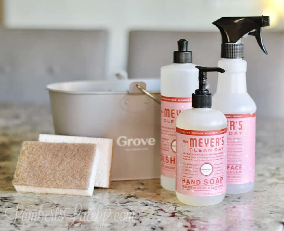 three mrs meyer's products next to a grove caddy on a counter.