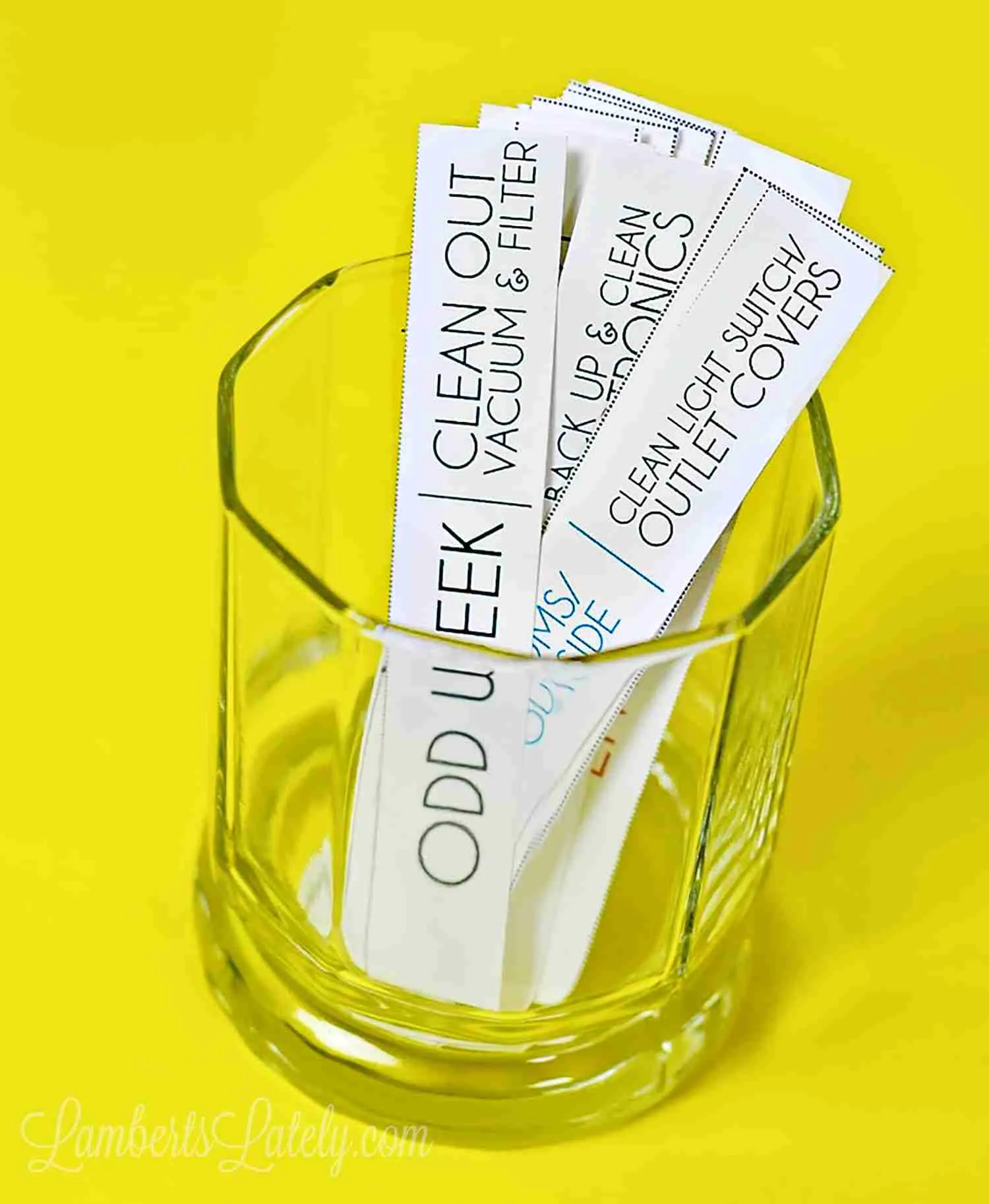 chore cards in a glass with yellow background