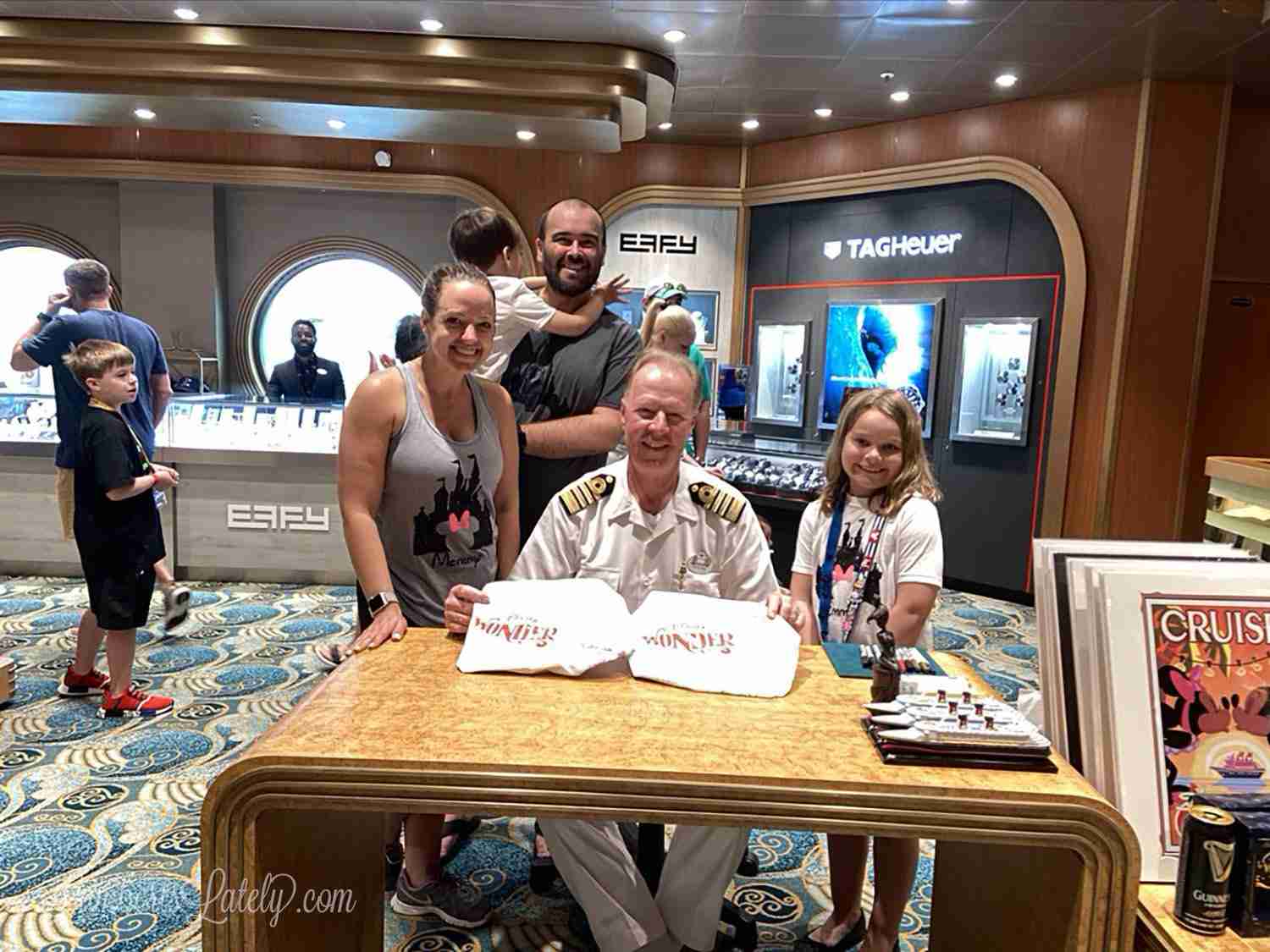 captain signing autographs on Disney Wonder.
