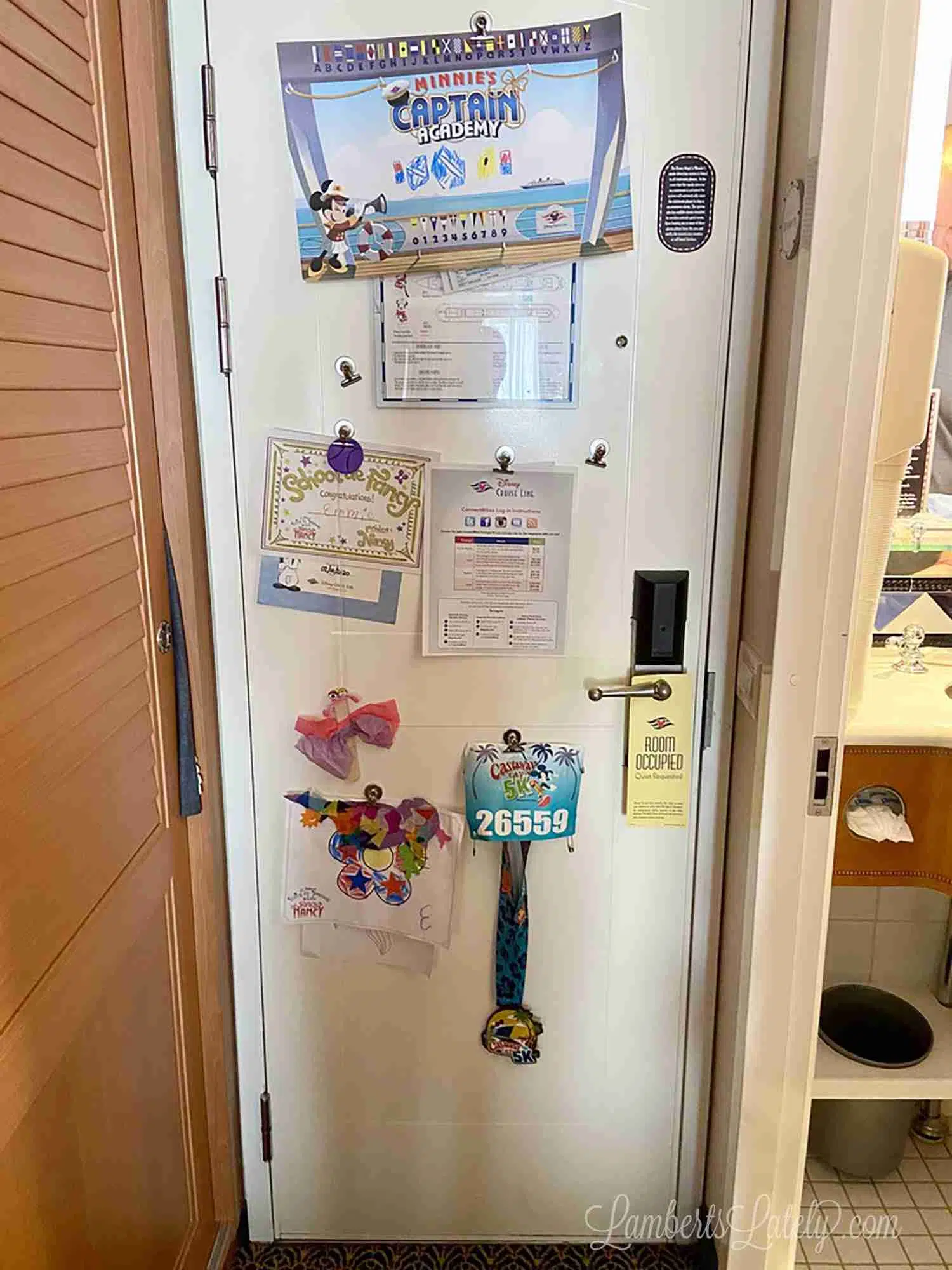 disney cruise cabin door from the inside with magnets holding papers.