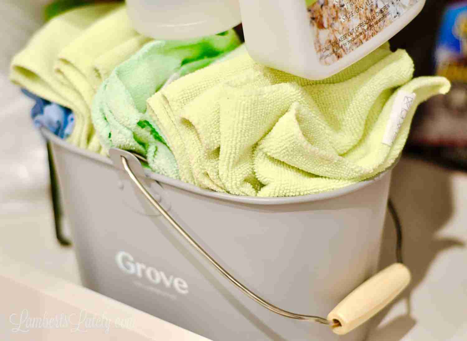 folded microfiber cleaning cloths in a Grove tub