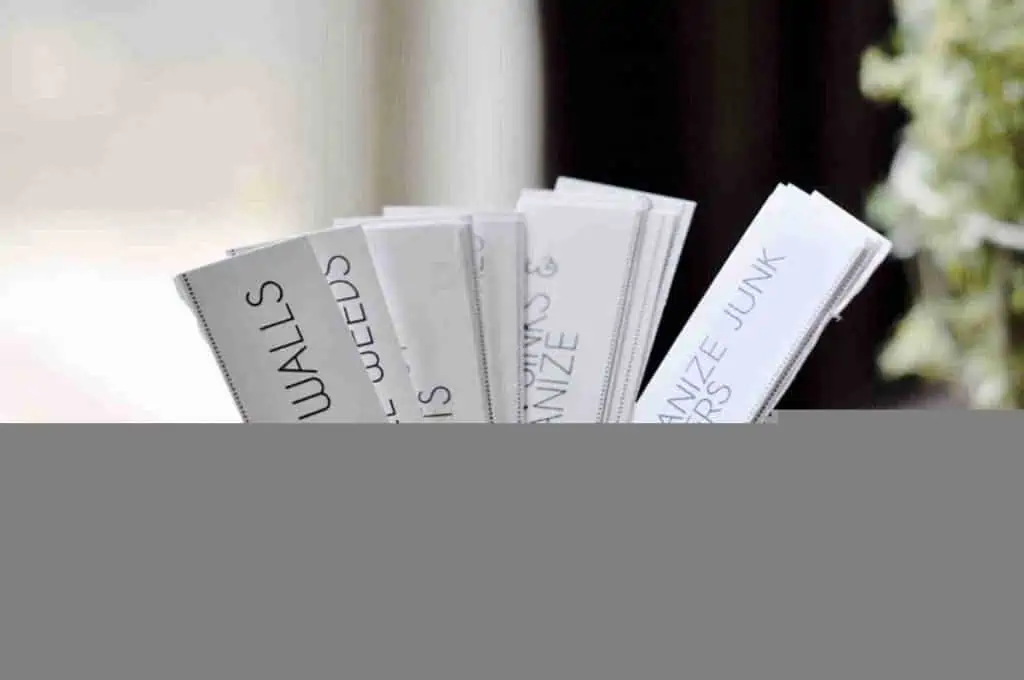 rectangular chore cards in a glass.