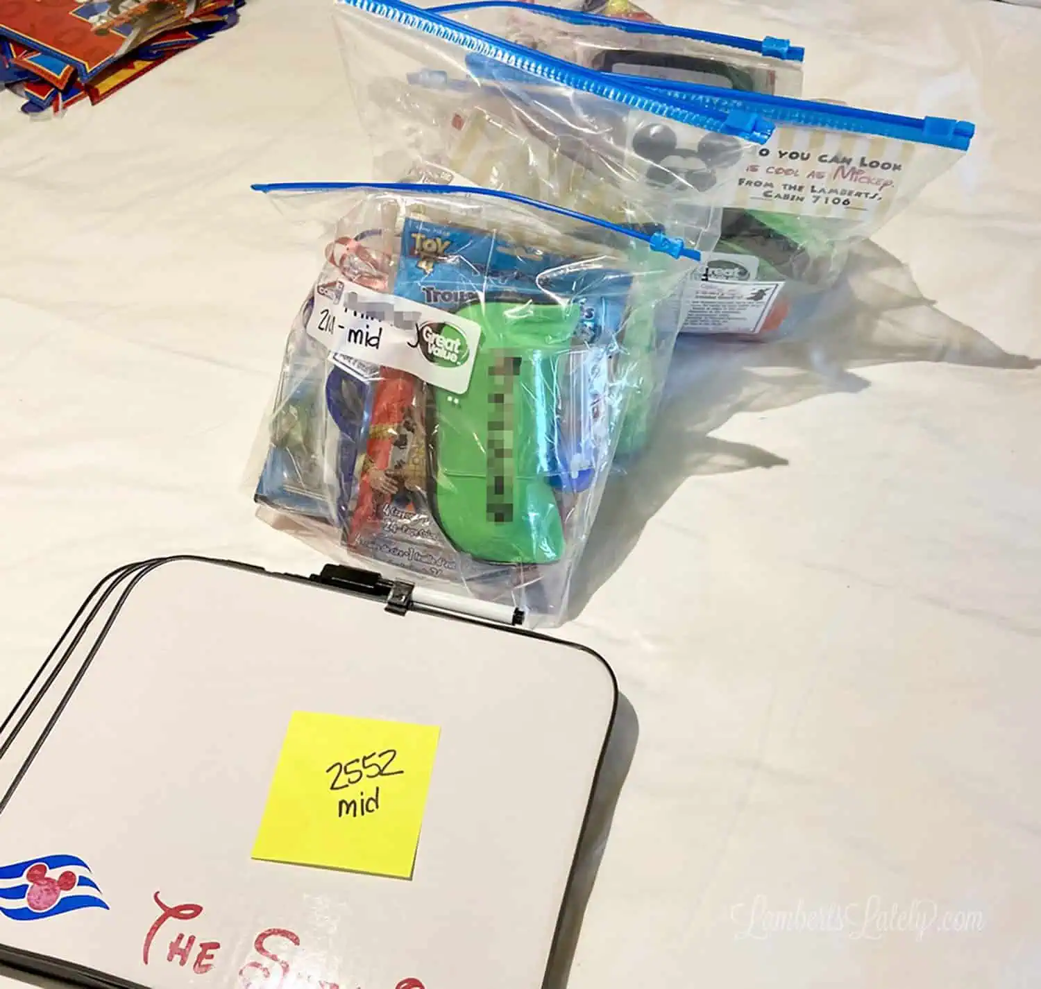 organizing fish extender gifts on a bed in a cruise cabin.