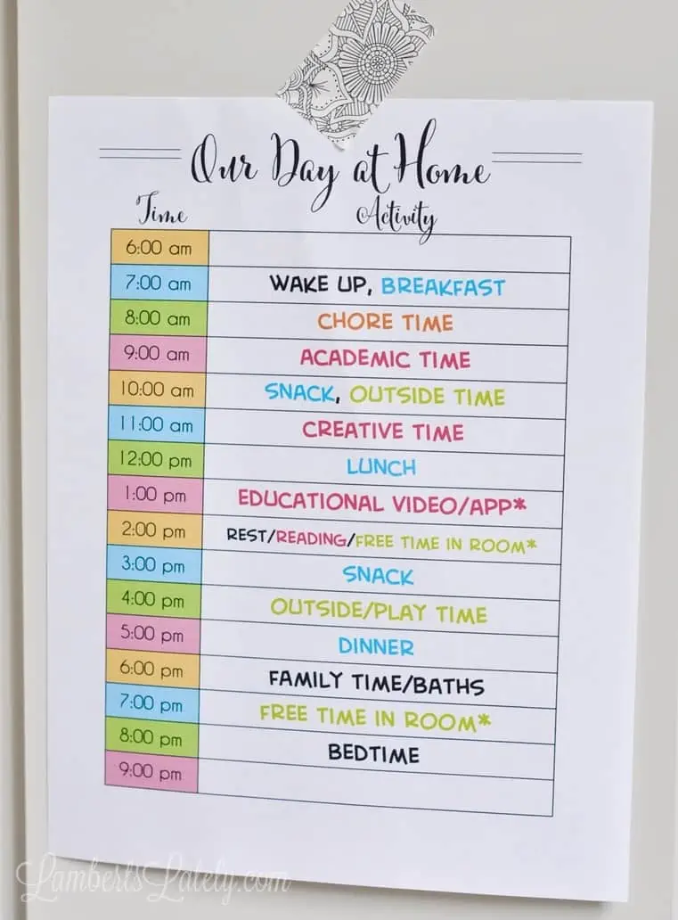our day at home printable filled in with a schedule, taped to a wall