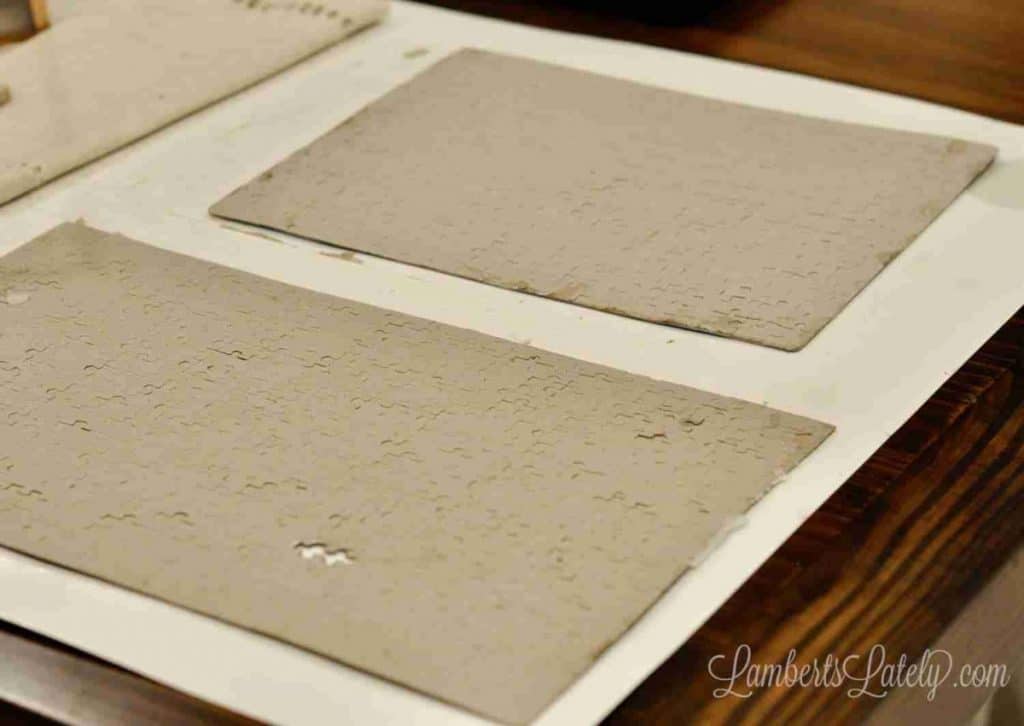 preserved puzzles turned over on poster board, before covering in mod podge.