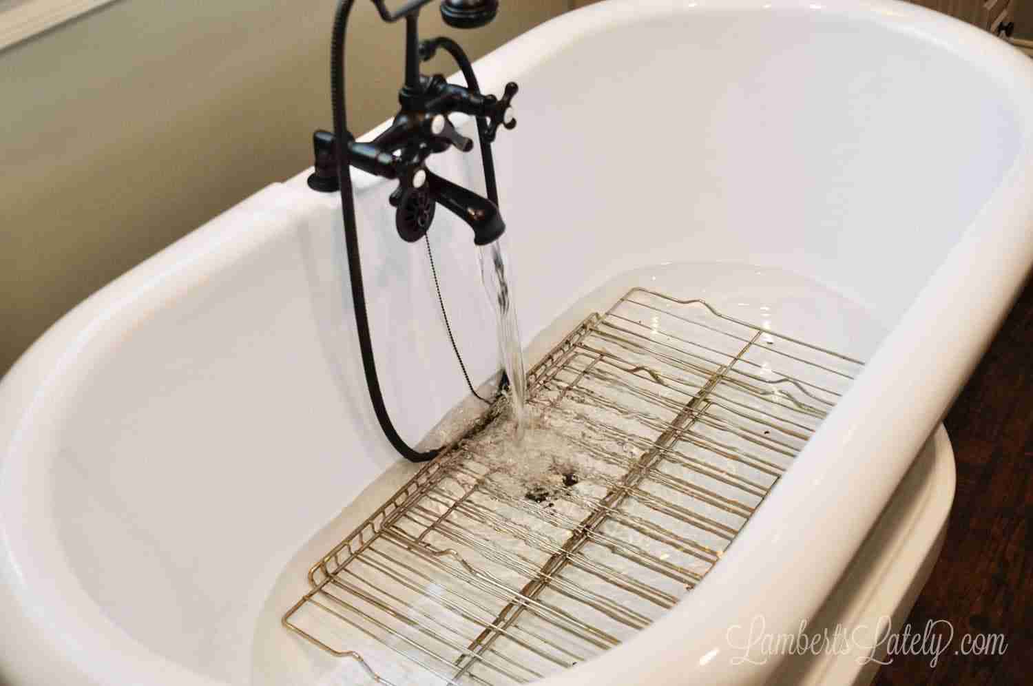 bathtub filling with water and oven racks