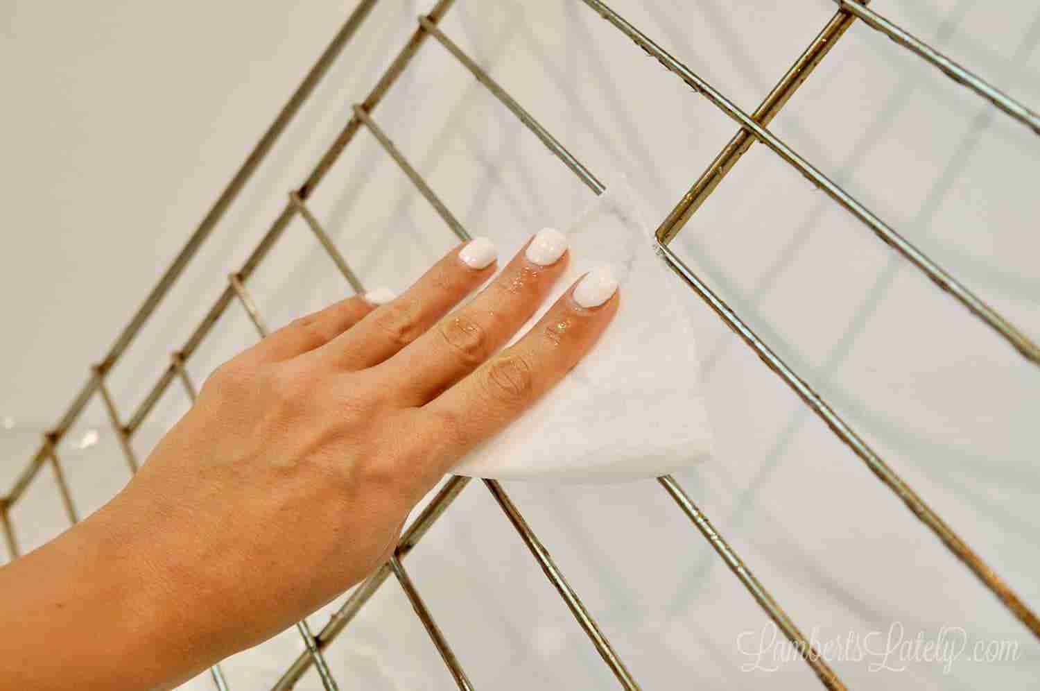 scrubbing an oven rack with a dryer sheet