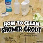Cleaning supplies and tools for shower grout cleaning on a tiled bathroom floor.