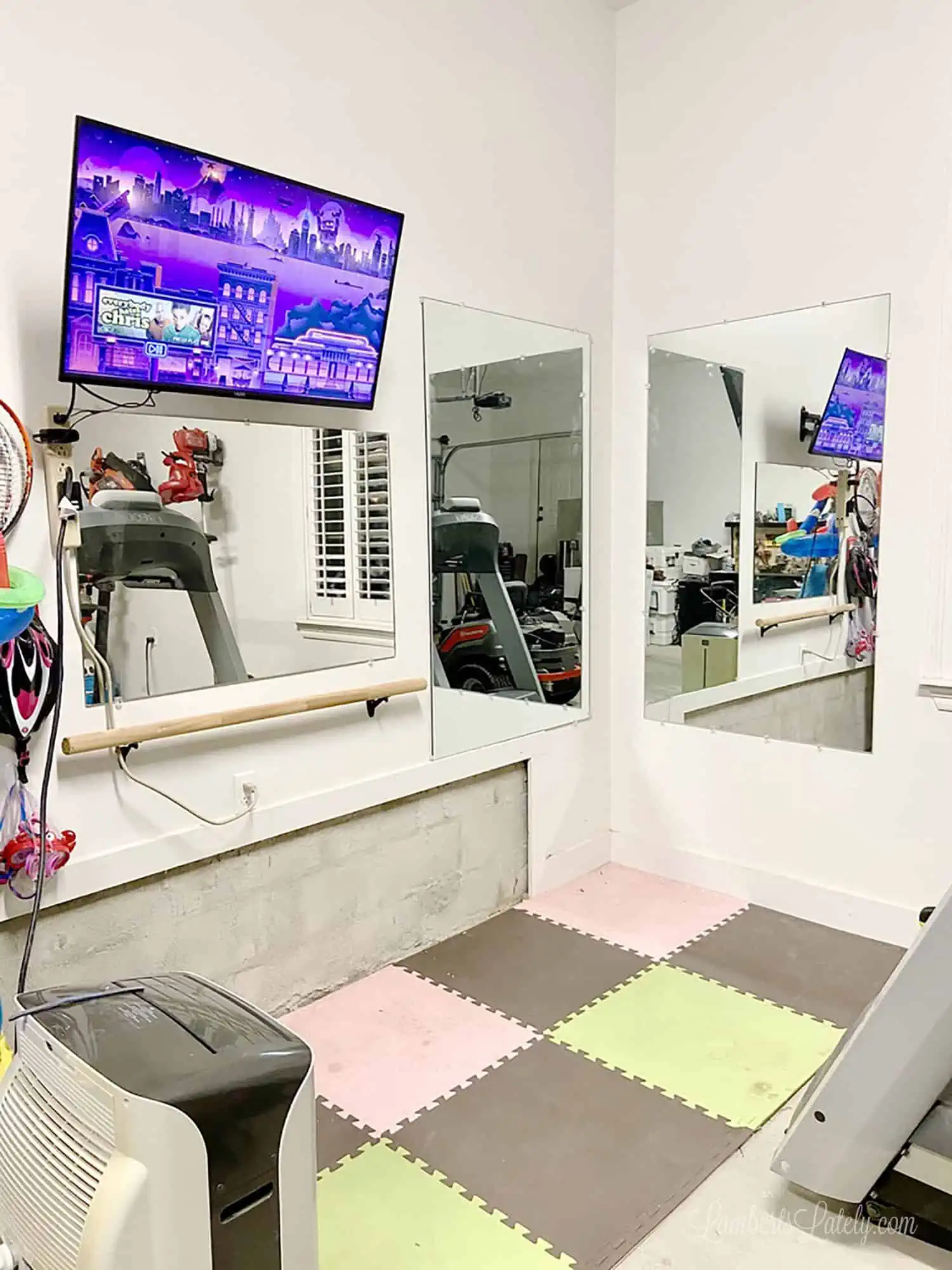 garage home gym with tv on.