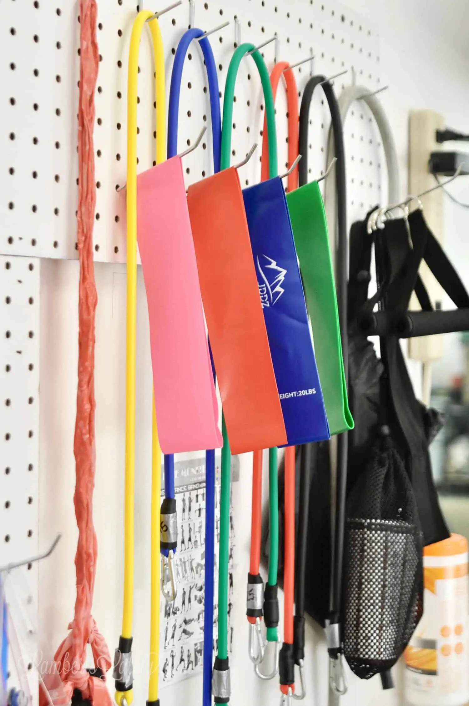 resistance bands hanging on a pegboard.