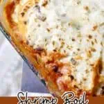 Close-up of shrimp boil fisherman's pie with melted cheese and golden crust.