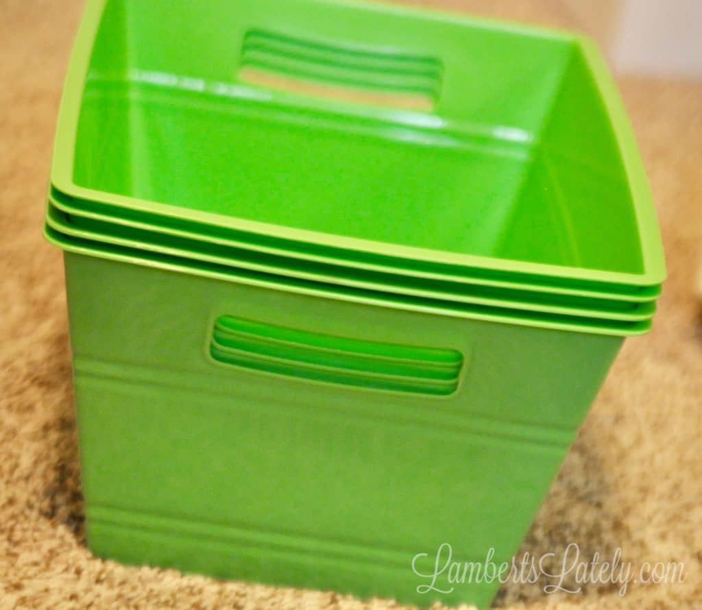 stack of green plastic bins