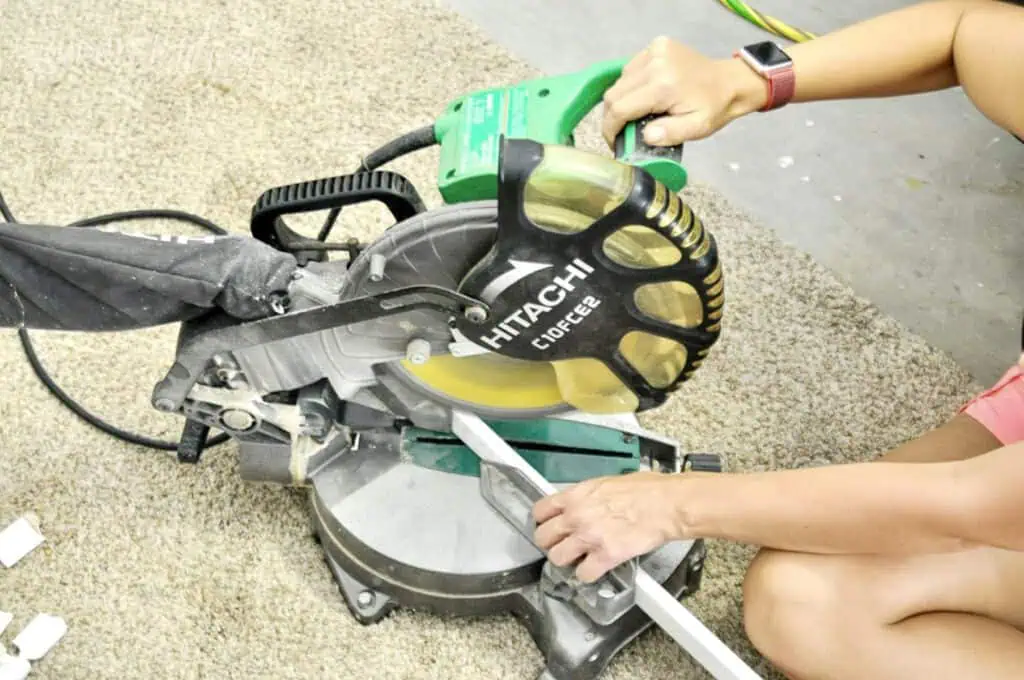using a miter saw to cut molding.