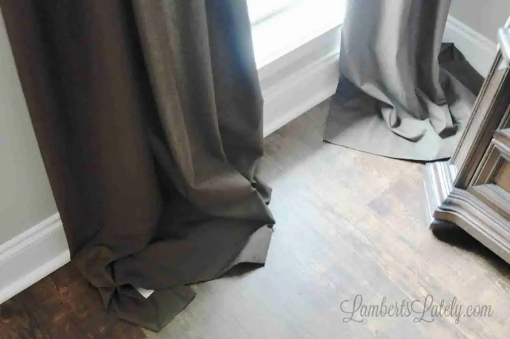 curtains pooling on a floor with extra fabric.