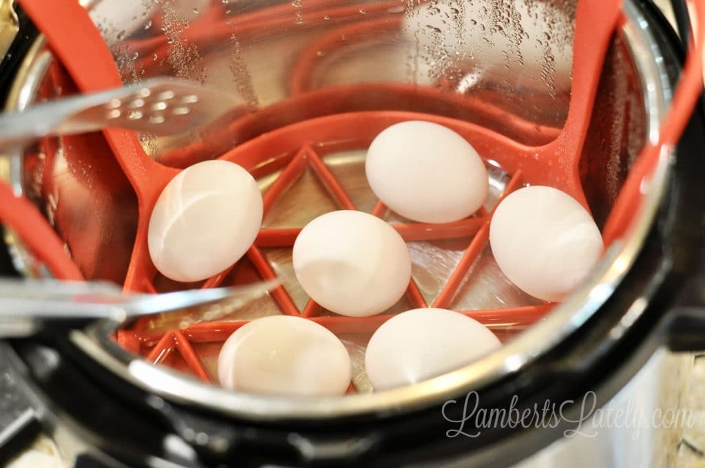removing hard boiled eggs from an instant pot.