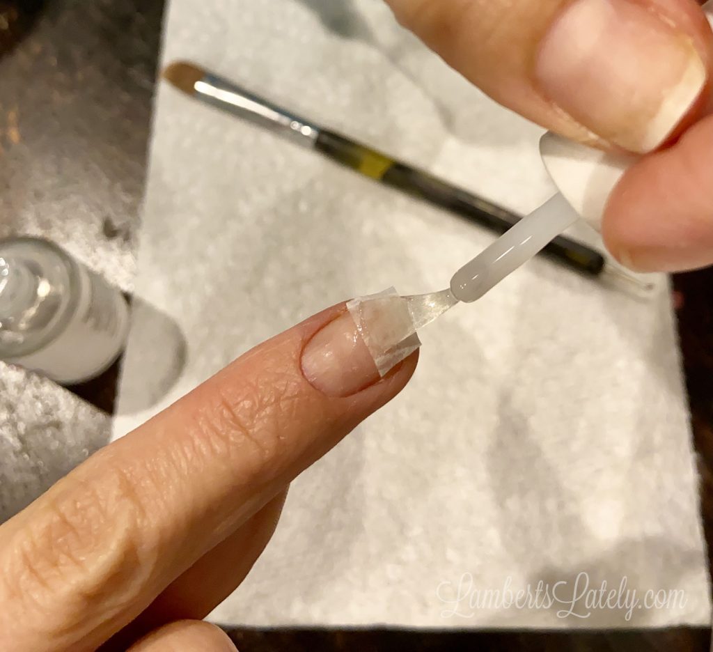 brushing nail with revel nail step 1.