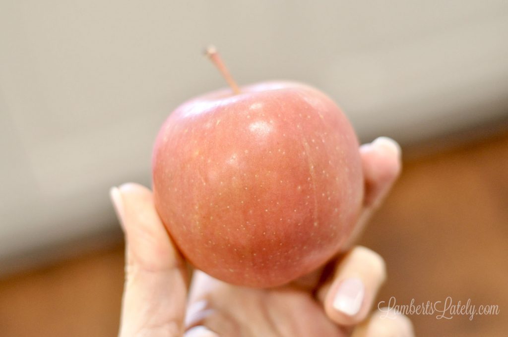 holding a red apple.