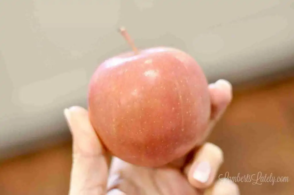 holding a red apple.