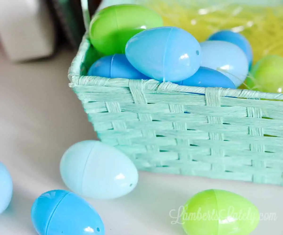 blue and green plastic easter eggs in a blue easter basket.