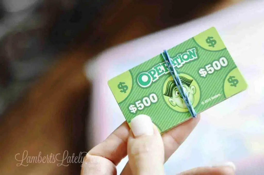 stack of play board game money in a rubber band
