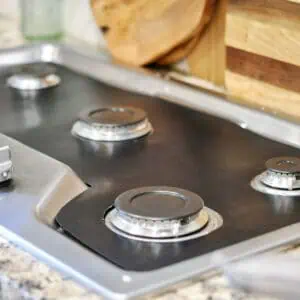 stove splash guard liner on a stovetop, no grates.