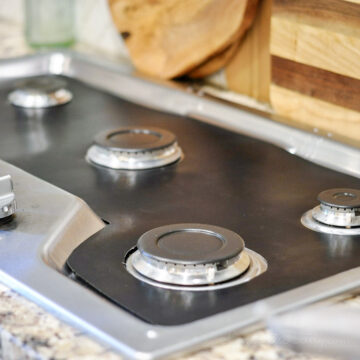 stove splash guard liner on a stovetop, no grates.