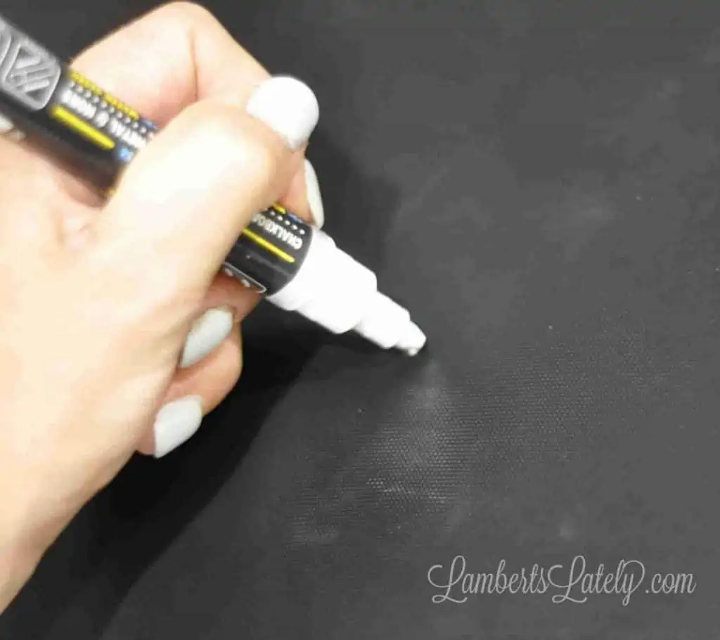 using a chalk marker to measure middle of stove eyes