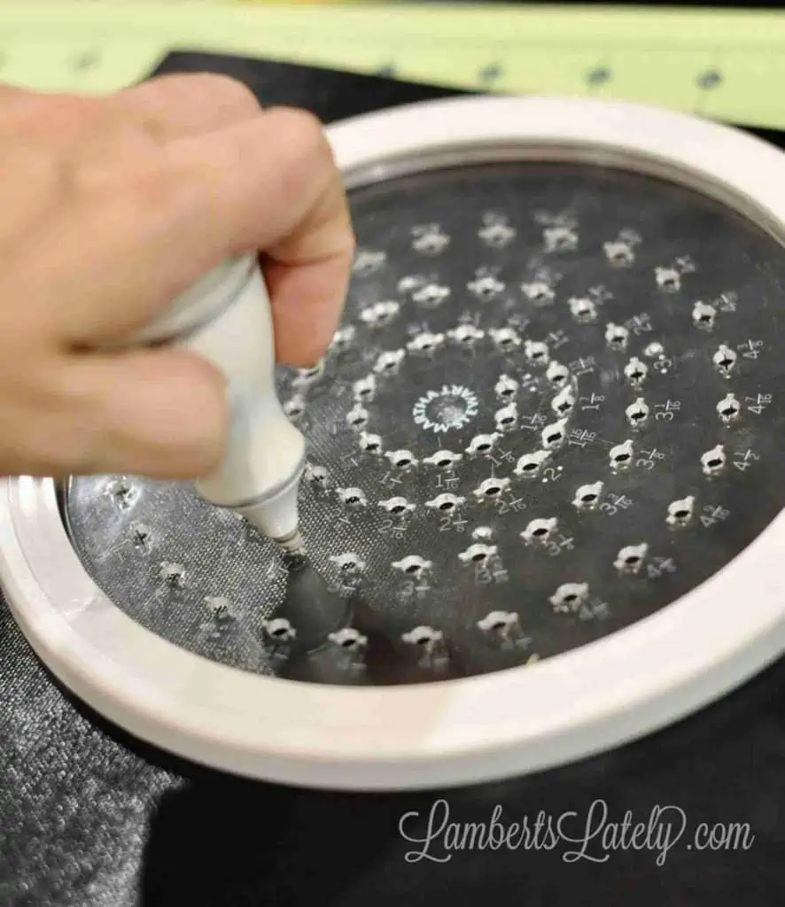 using a circular cutter to make eye holes in splatter guard
