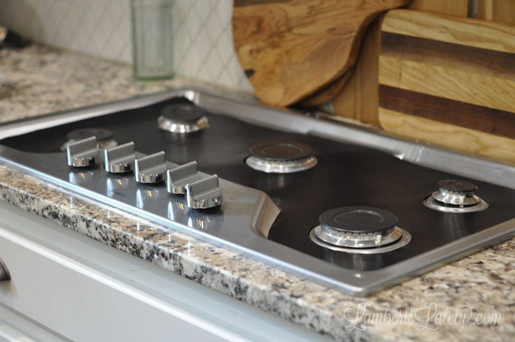 diy stove splatter guard on a gas stovetop