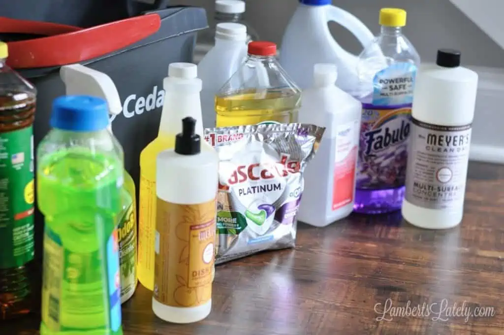 different cleaners on a floor in front of a mopping bucket.