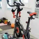 Home gym with Schwinn IC4 bike and tablet for DIY Peloton setup.