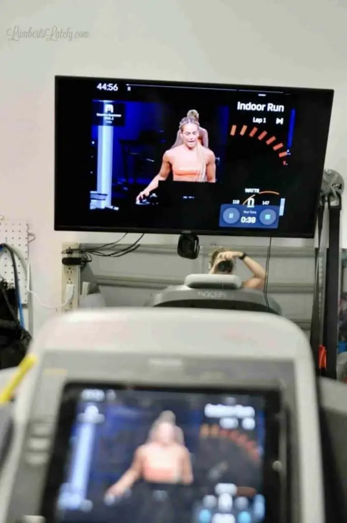 looking at a tv screen over the top of a treadmill.