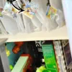 Organized board game storage with file bags and labels for easy access.