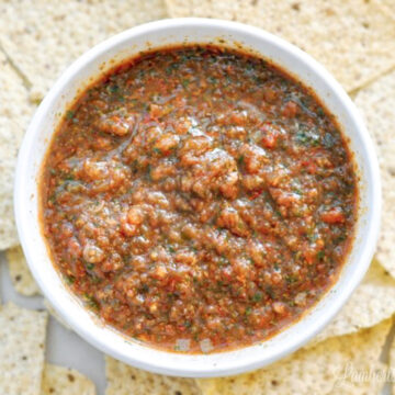 bowl of copycat mexican restaurant salsa surrounded by chips.