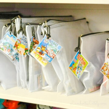 filing bags of board games in a cabinet.