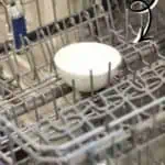 Dishwasher with a bowl of vinegar in the middle of the top rack for cleaning.