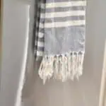 Clean towel hanging on a stainless steel dishwasher handle with text overlay.