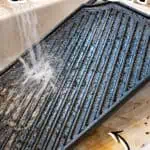 Cleaning a cast iron griddle with water and salt for maintenance.