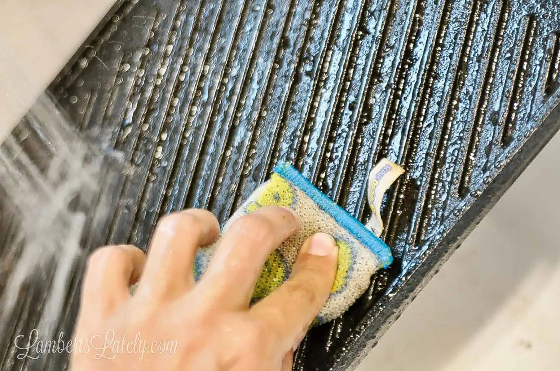 washing the cast iron with water and scrubbing with a sponge.