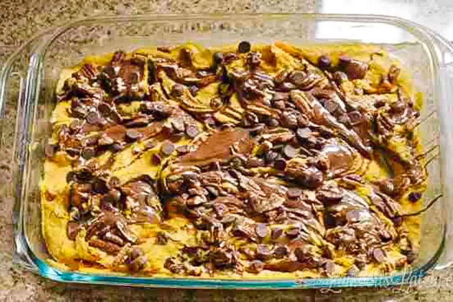 swirled ingredients for pumpkin nutella earthquake cake in a baking dish, before baking.