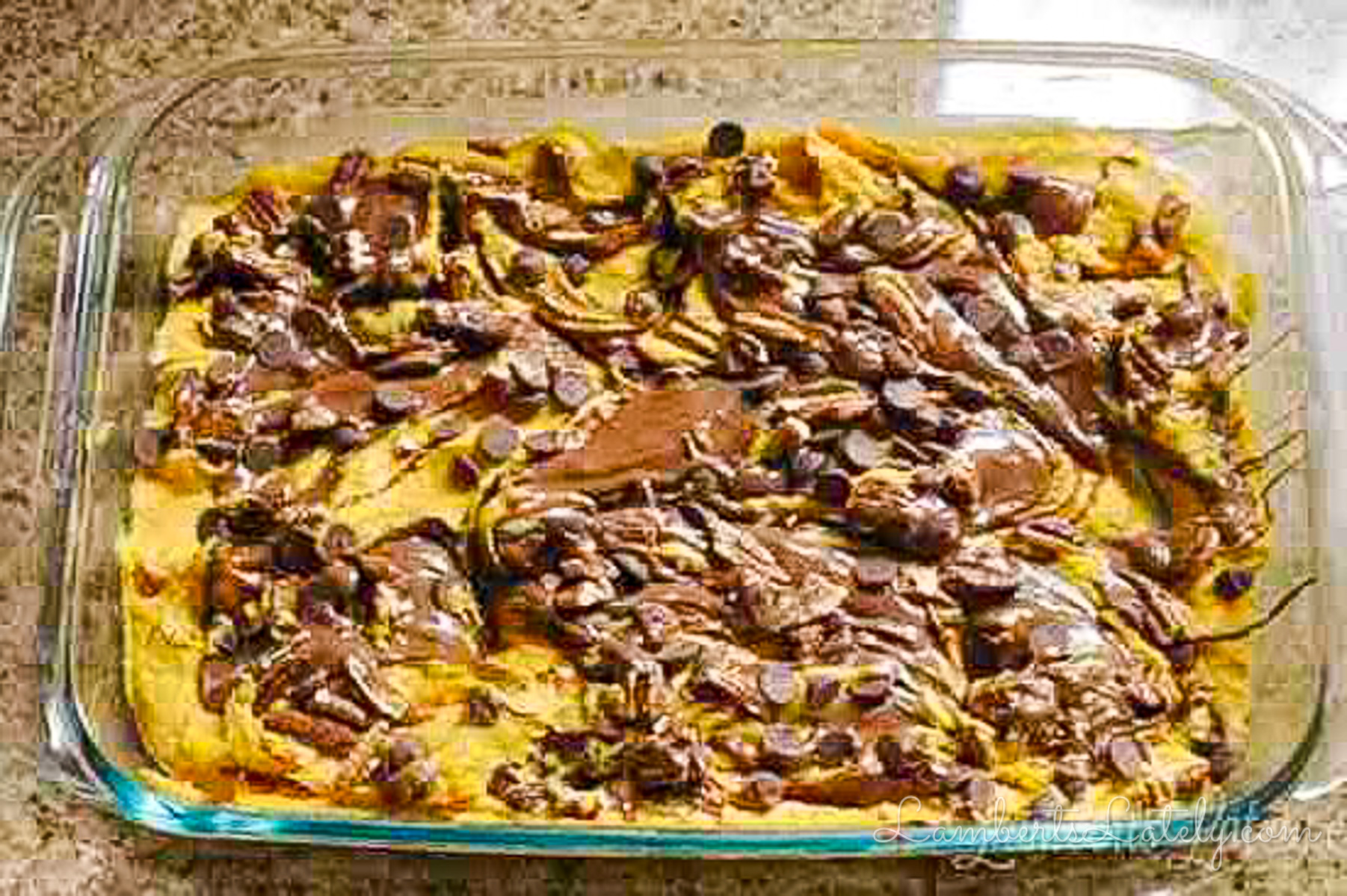 swirled ingredients for pumpkin nutella earthquake cake in a baking dish, before baking.