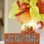 Colorful DIY mesh bow Christmas tree topper with ornaments and decorations.