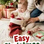 Happy baby with Christmas ornaments and tree, celebrating festive season with family.