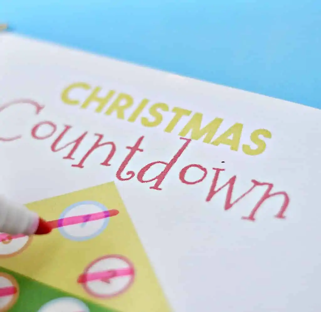 Christmas countdown printable with colorful circles and a red marker pen.