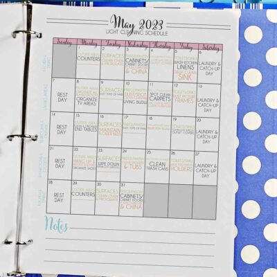monthly cleaning schedule in a notebook.