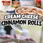 Cream cheese cinnamon rolls with frosting and baking ingredients on a kitchen counter.
