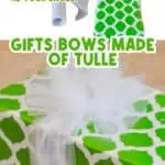 Person tying a tulle bow on a gift with green and white wrapping paper.