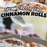 Fresh cinnamon rolls with cream cheese frosting and ingredients on the counter.