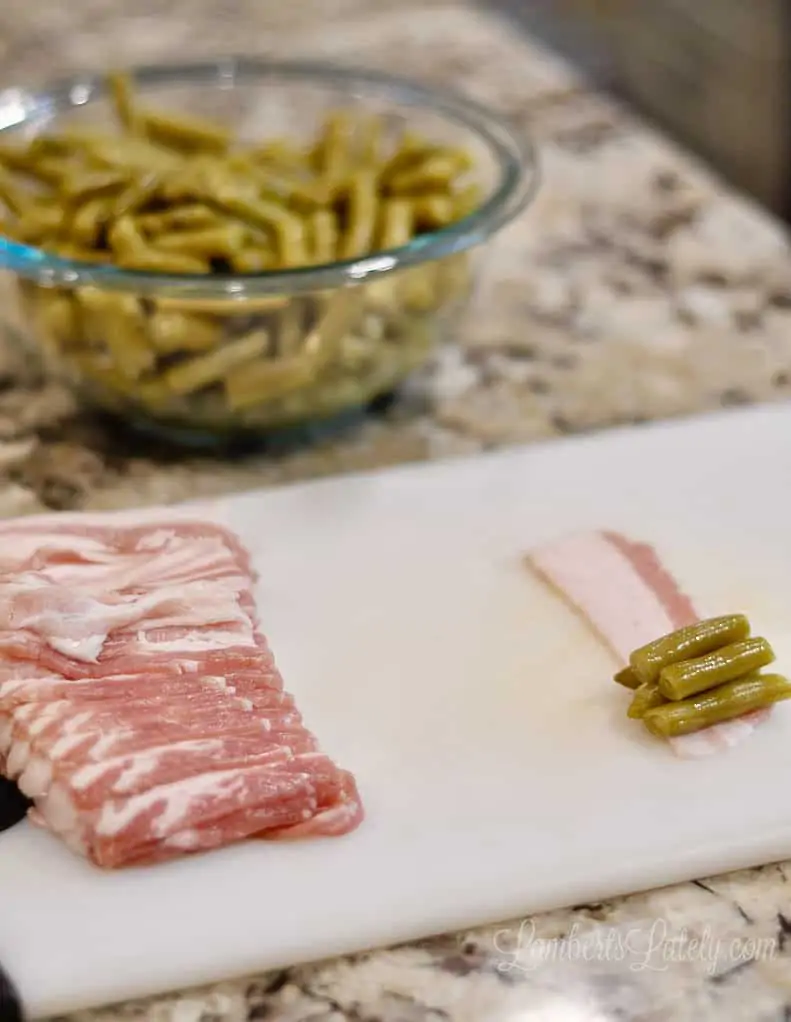 cutting board with sliced bacon and green beans