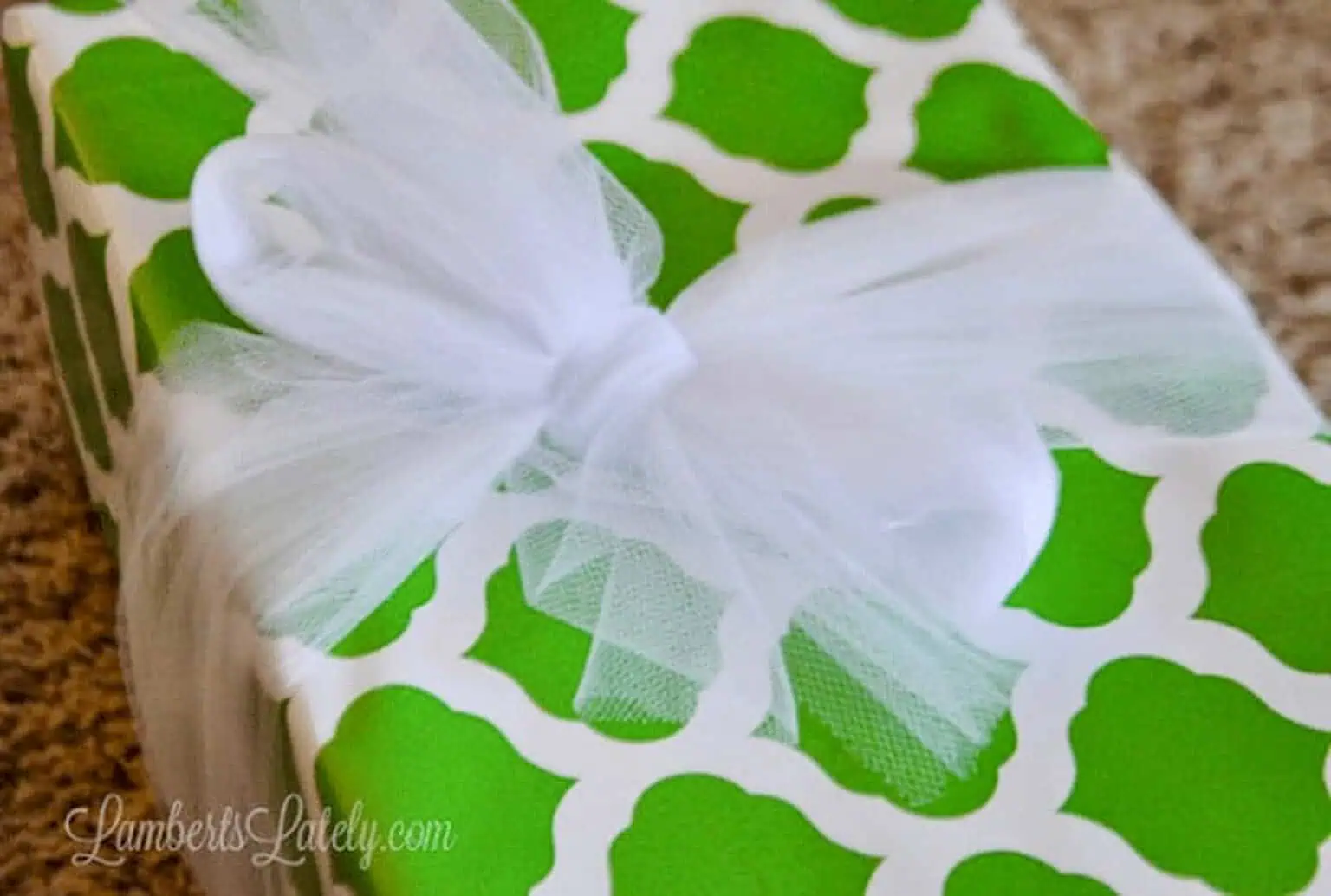 shoelace bow tied with tulle around a gift.